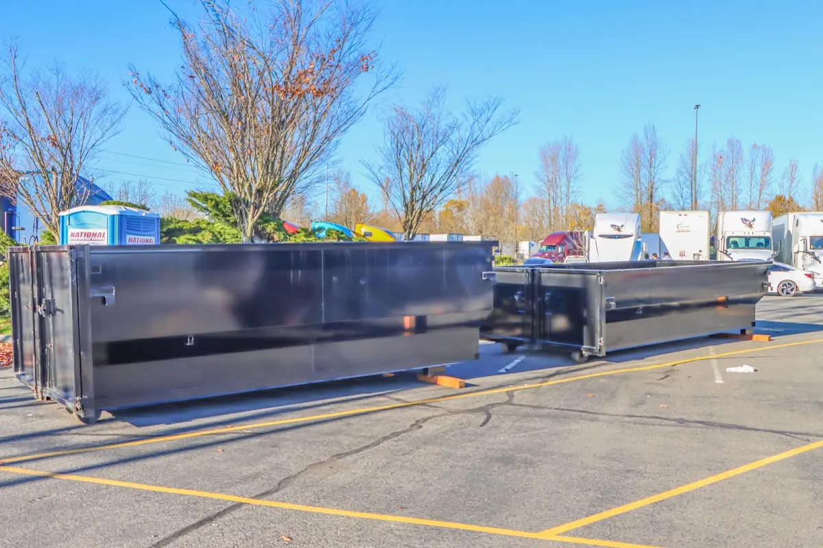 Professional dumpster rental service with roll-off container on residential driveway in Davis